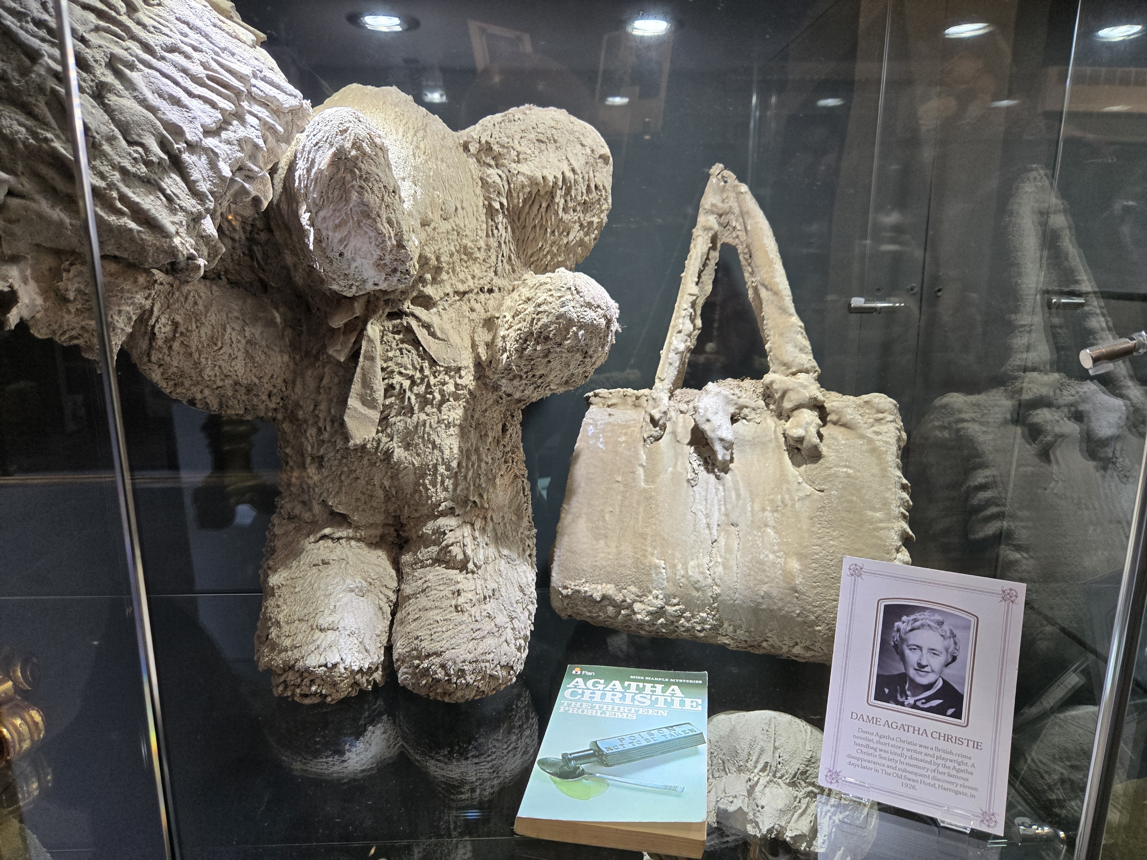 Agatha Christie's handbag, covered in stone displayed in case in museum