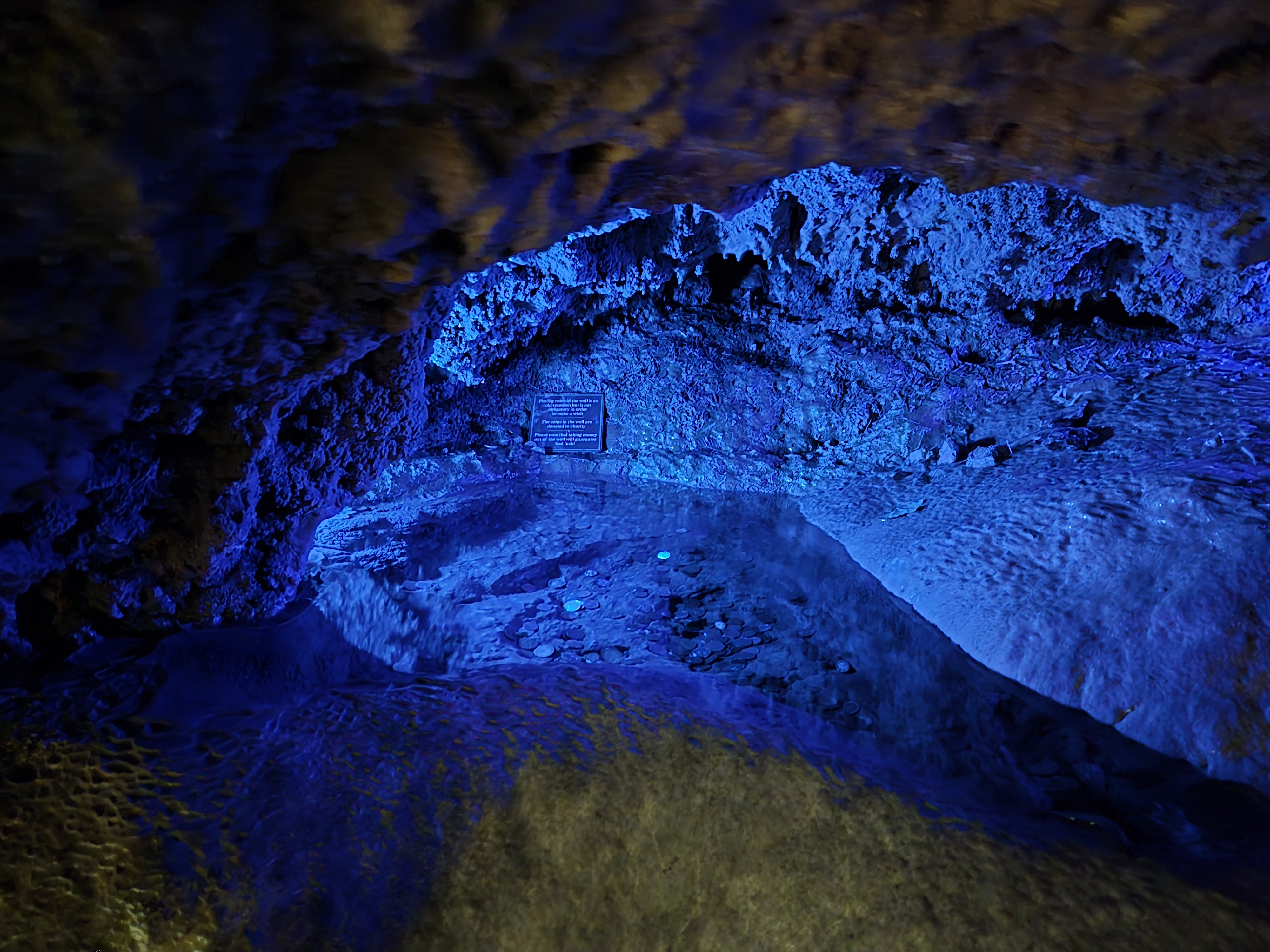 illuminated pool in cave