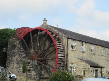 Stone building with water wheel at side