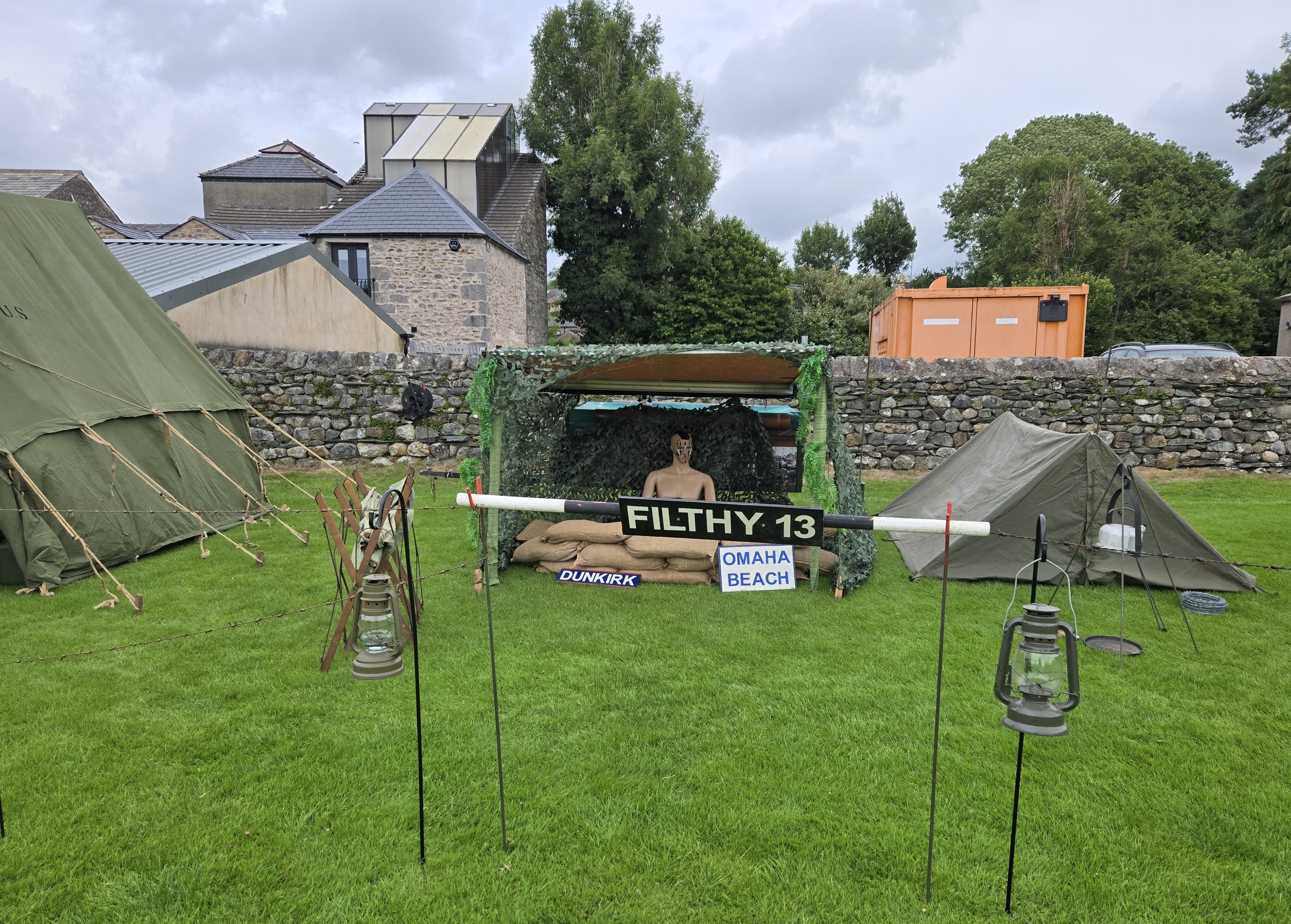 military field display - tent with sign reading FILTHY 13